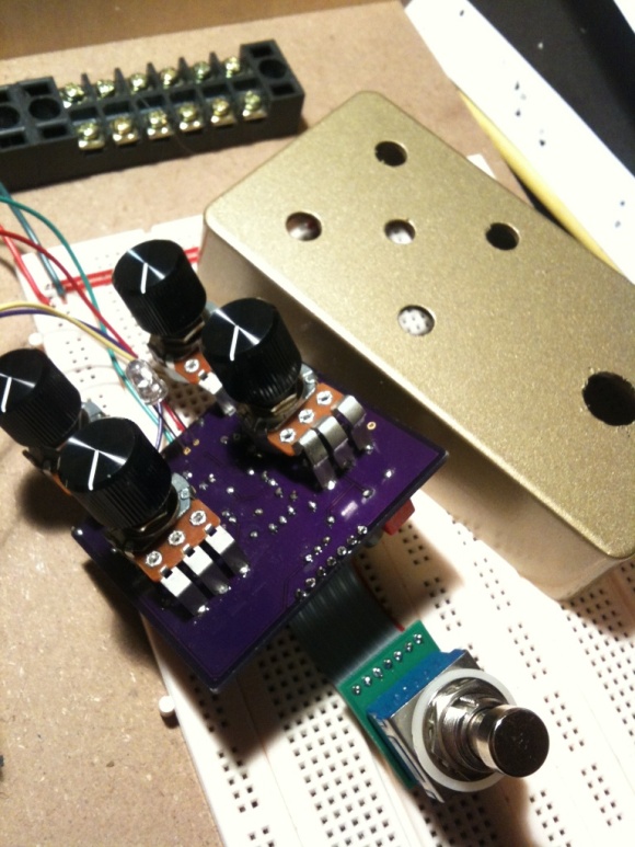 The ill-fated gold enclosure next to the assembled Fuzz circuit